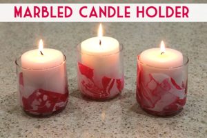 Great fun! Make these marbled Valentine candle holders using red and white fingernail polish!