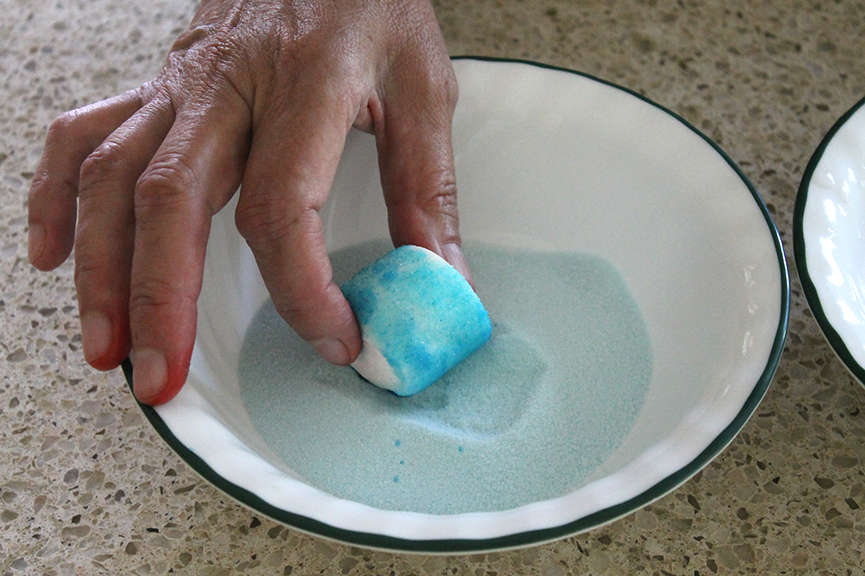 Roll the marshmallows in the Jell-O