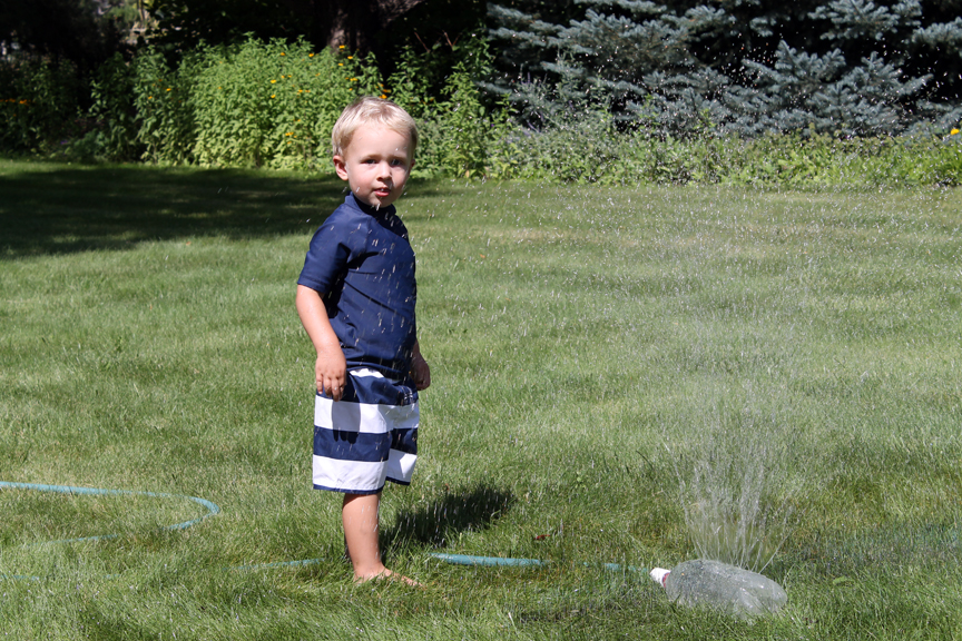 A pop bottle sprinkler is easy to make and give kids hours of fun playing in the water.