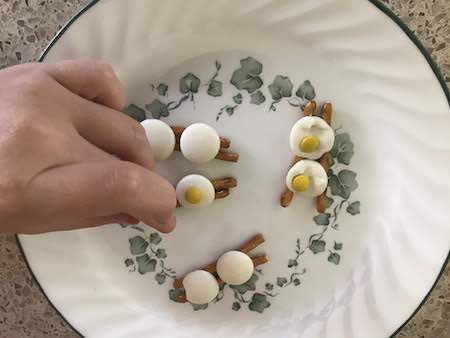 Quickly press a yellow M&M in each white candy melt.
